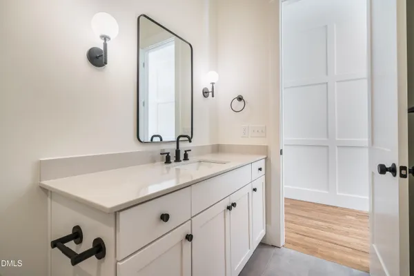 a bathroom with a double vanity sink and a mirror