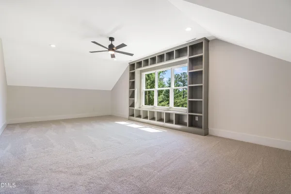 a view of a livingroom with a fireplace and window