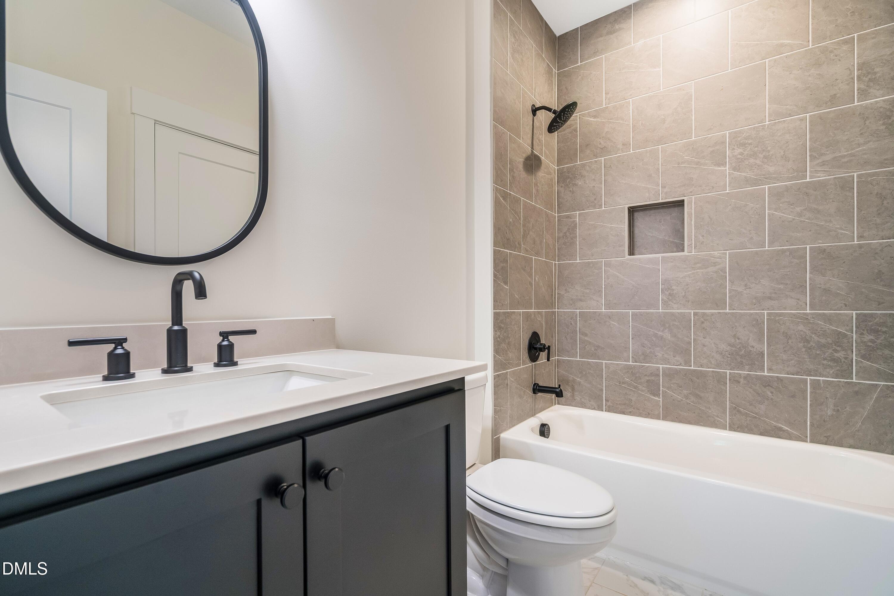 14020 Durant Road Raleigh, NC 27614 - Photo 80 of 86 a bathroom with a sink a toilet and a mirror