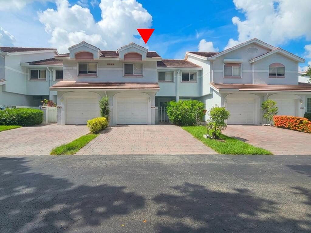 6207 Old Court Road, Unit 604 Boca Raton, FL 33433 - Photo 2 of 22 a front view of a house with a yard and potted plants