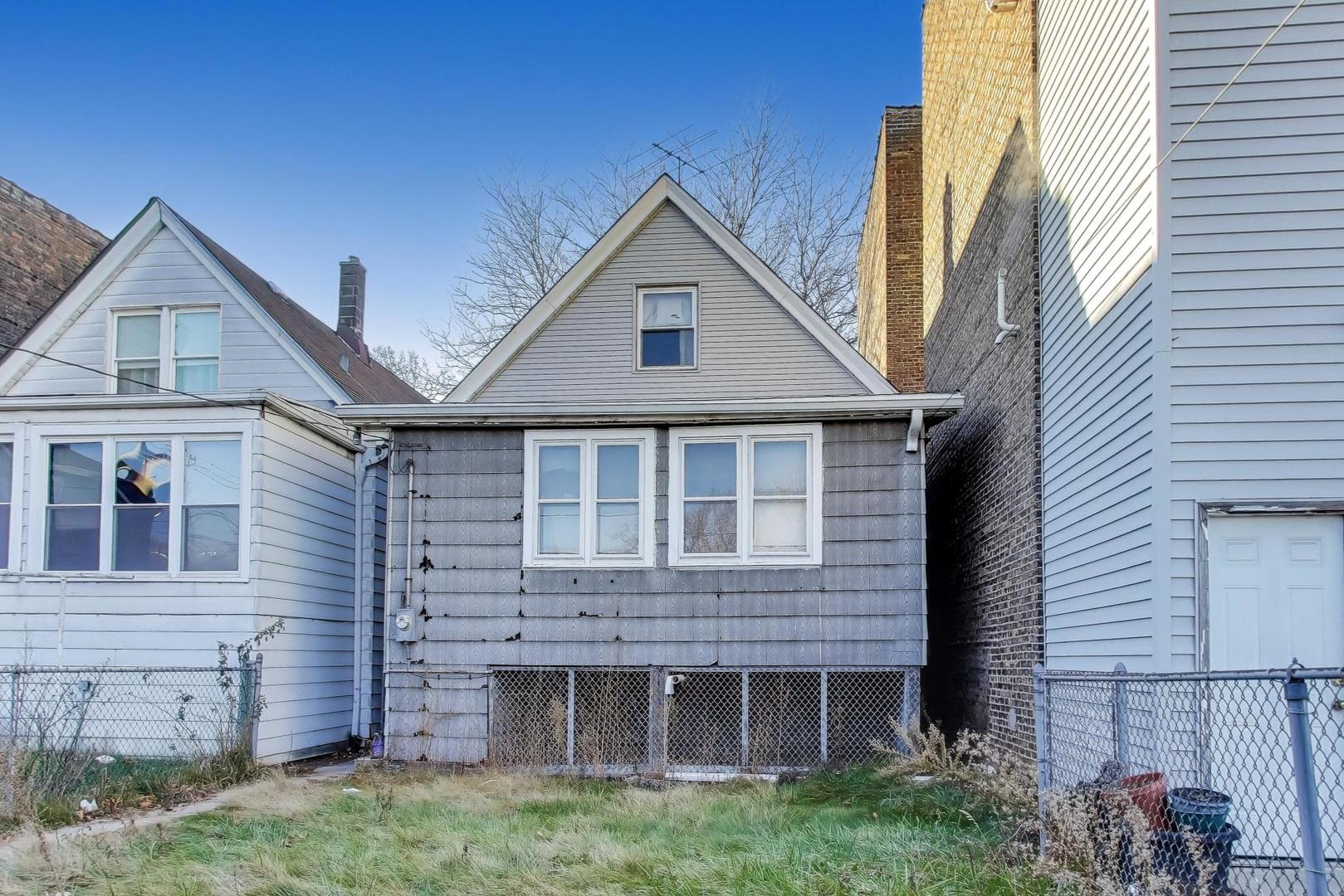 2023 North Kedvale Avenue Chicago, IL 60639 - Photo 13 of 18 a front view of a house with a yard