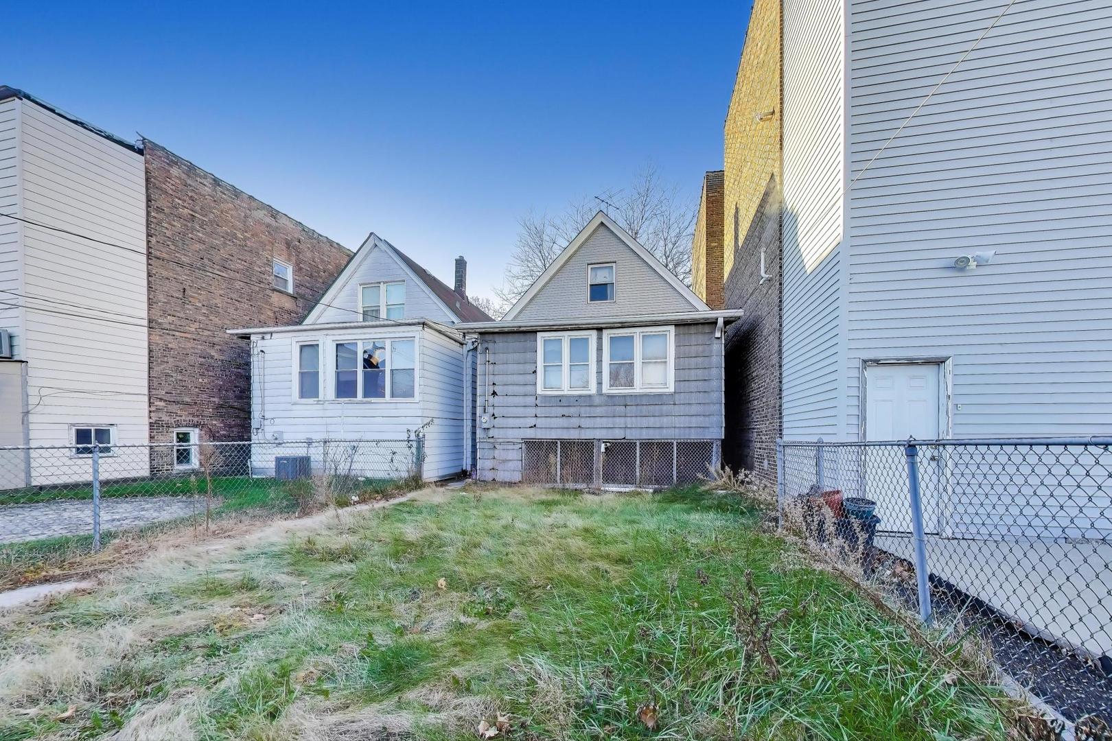2023 North Kedvale Avenue Chicago, IL 60639 - Photo 14 of 18 a front view of a house with a yard