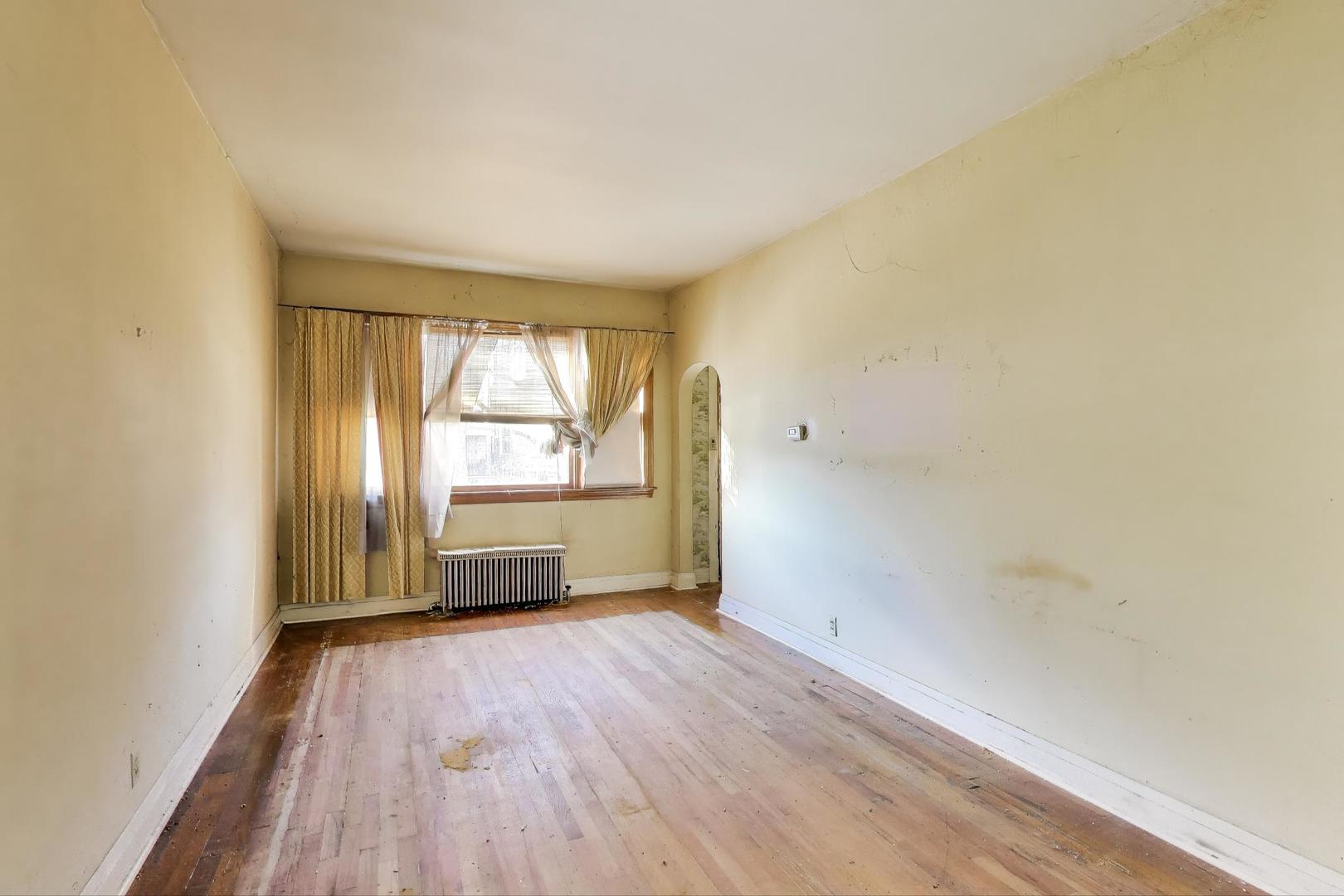 2023 North Kedvale Avenue Chicago, IL 60639 - Photo 2 of 18 an empty room with wooden floor and windows