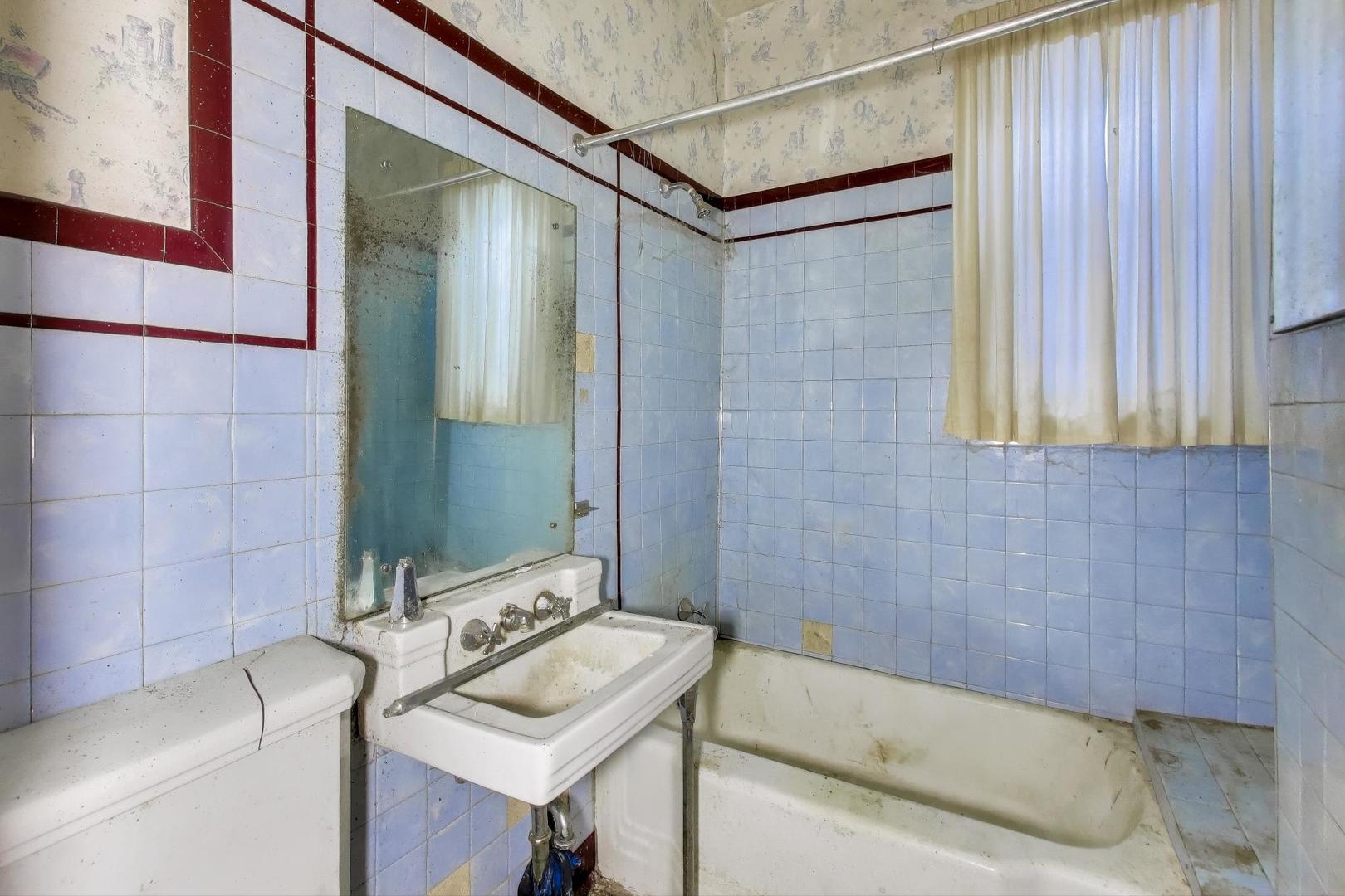2023 North Kedvale Avenue Chicago, IL 60639 - Photo 7 of 18 a bathroom with a sink and a bathtub