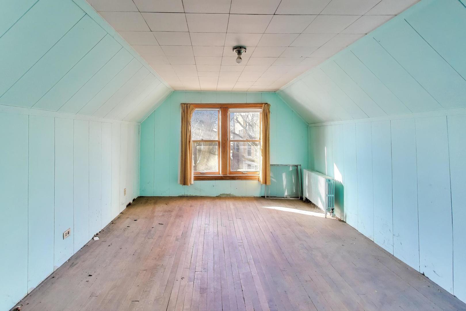 2023 North Kedvale Avenue Chicago, IL 60639 - Photo 9 of 18 wooden floor in an empty room with a window
