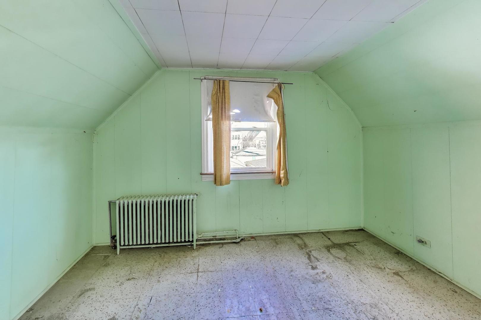 2023 North Kedvale Avenue Chicago, IL 60639 - Photo 10 of 18 a view of a room with a window and a ceiling fan