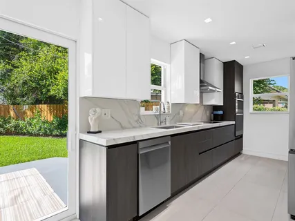 a kitchen with a sink and a refrigerator