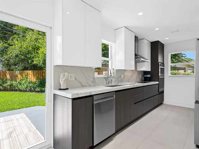 a kitchen with a sink and a refrigerator