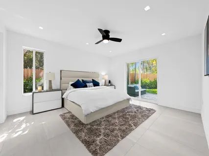 a bedroom with a large bed and a window