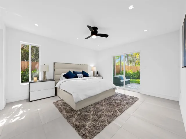 a bedroom with a large bed and a window