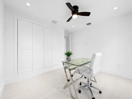 a view of a room with a hanging light and kitchen