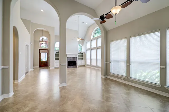 a view of gallery with windows and wooden floor