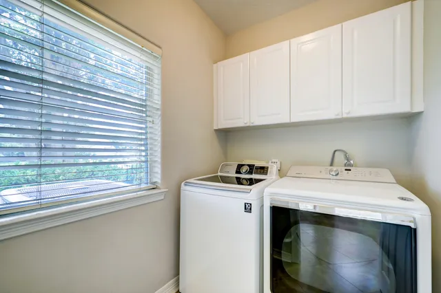 a kitchen with stove cabinets and utility