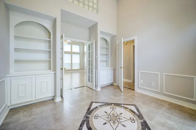 an empty room with cabinet and wooden floor