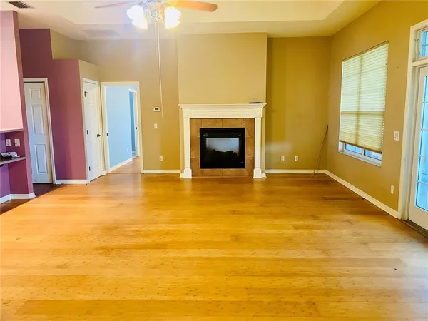 a view of an empty room with a fireplace