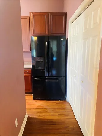 a view of walk in closet with wooden floor