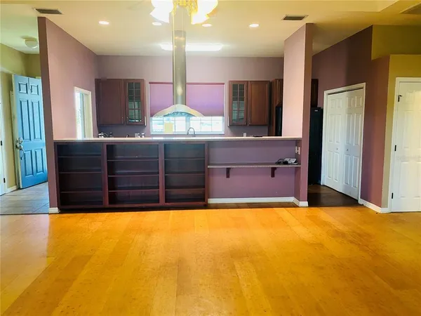 a view of kitchen with kitchen island a sink stainless steel appliances and cabinets