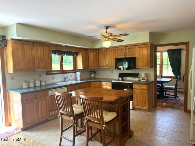 452 Pattison Road North Adams, MA 01247 - Photo 4 of 28 a kitchen with stainless steel appliances granite countertop a stove top oven a sink dishwasher and a microwave oven on the blue kitchen countertops