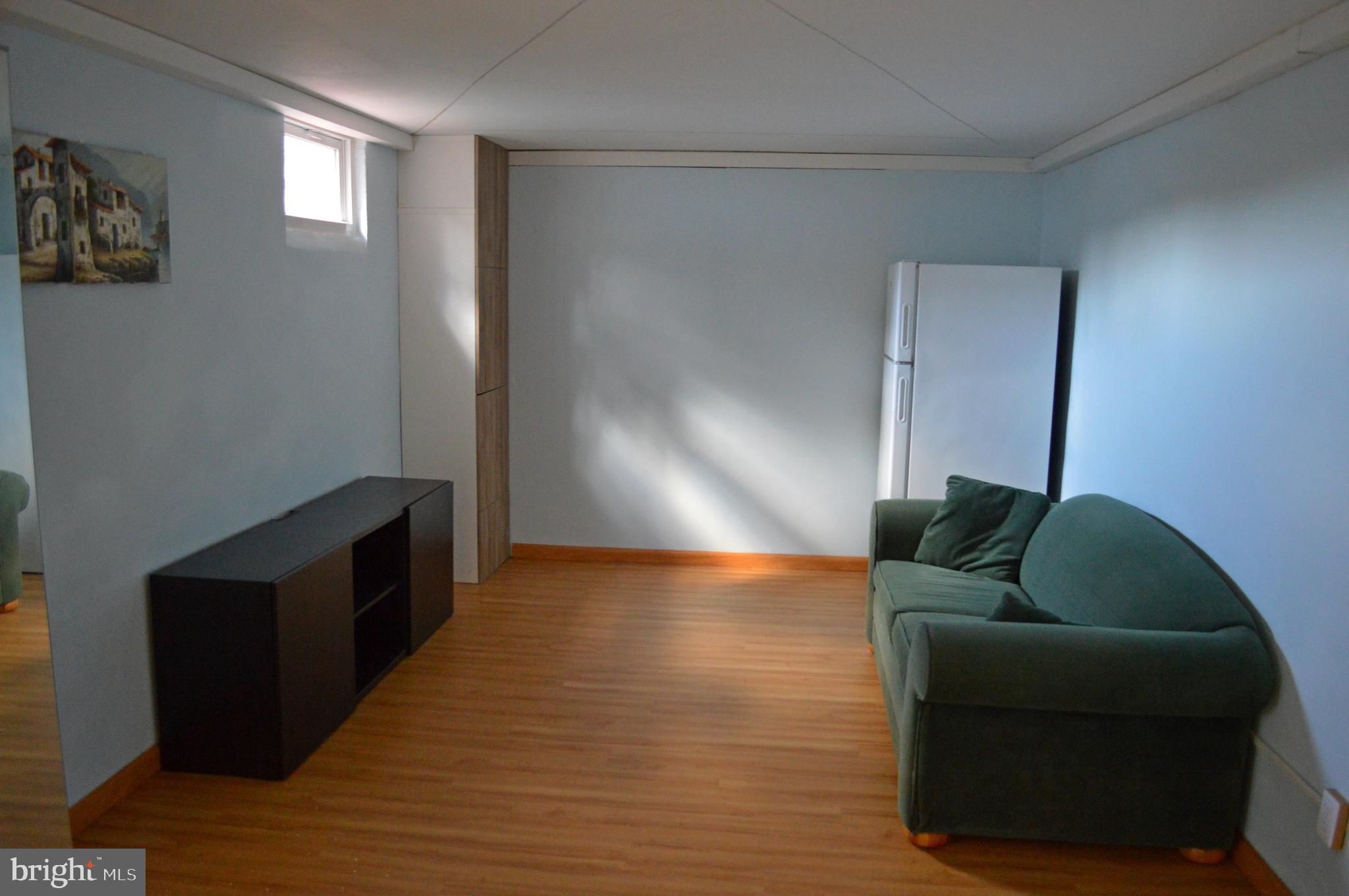 5953 Kedron Street Springfield, VA 22150 - Photo 21 of 28 a living room with furniture and a wooden floor