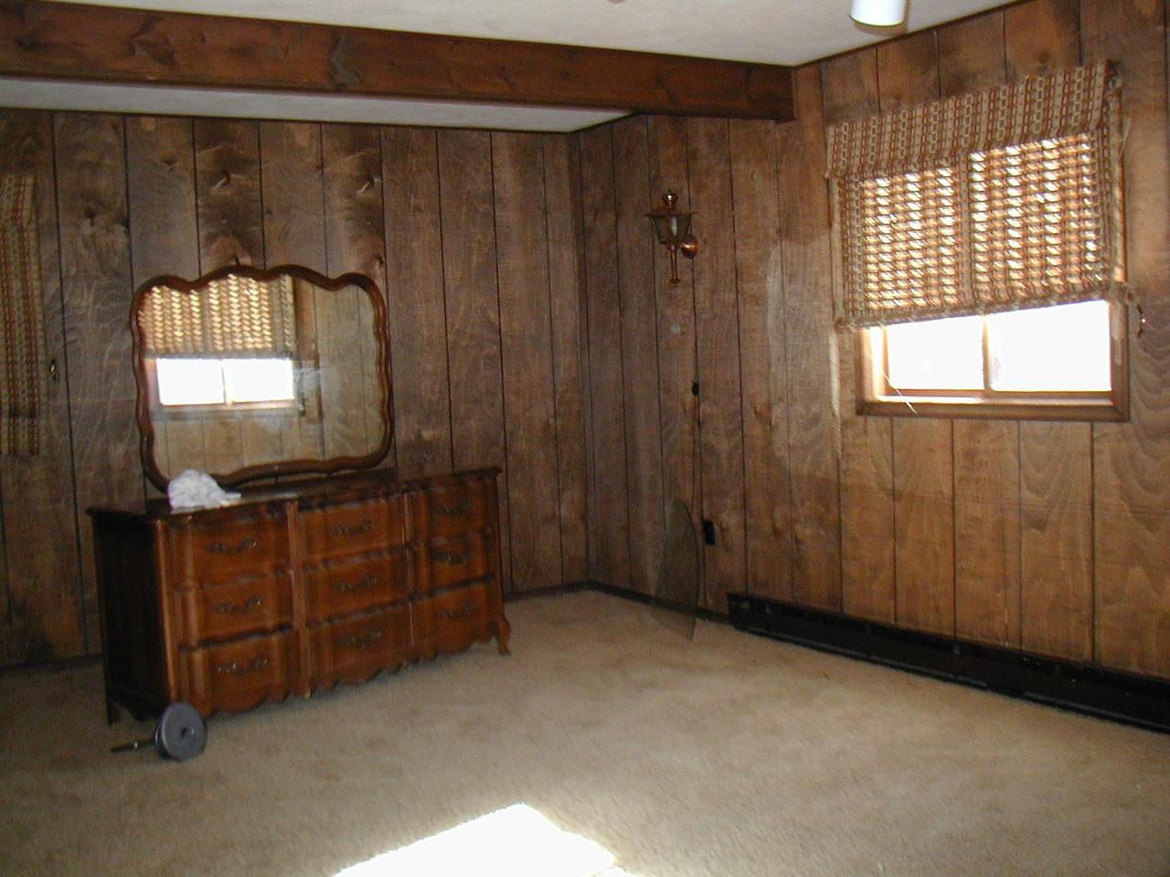 987 Canterbury Road Bushkill, PA 18324 - Photo 6 of 6 a room with a mirror on dresser and a wooden floor