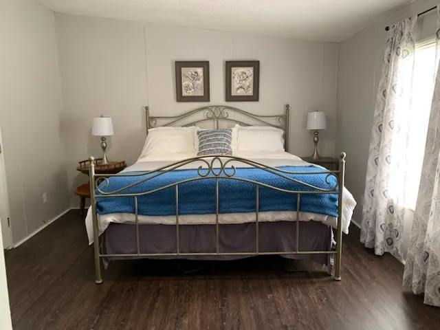 a bedroom with bed and a window