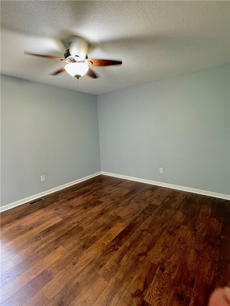 516 Carole Avenue Anderson, SC 29625 - Photo 20 of 34 This inviting bedroom features rich hardwood flooring and a functional ceiling fan.