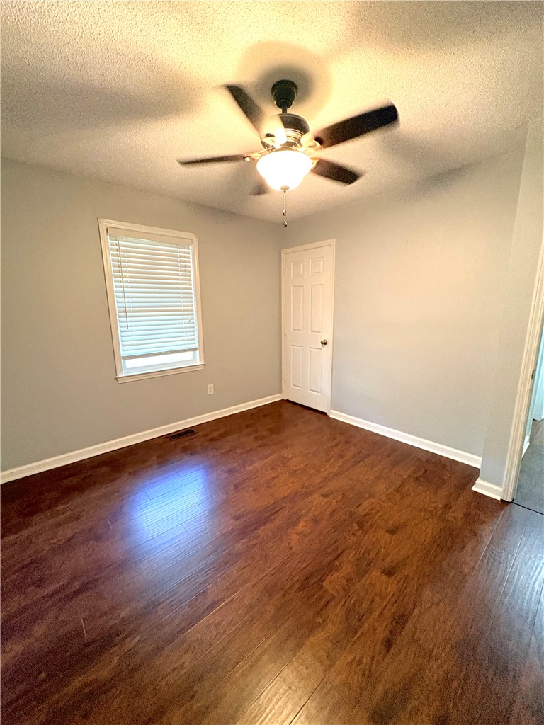 516 Carole Avenue Anderson, SC 29625 - Photo 25 of 34 This inviting bedroom features rich hardwood flooring and a functional ceiling fan for comfort.