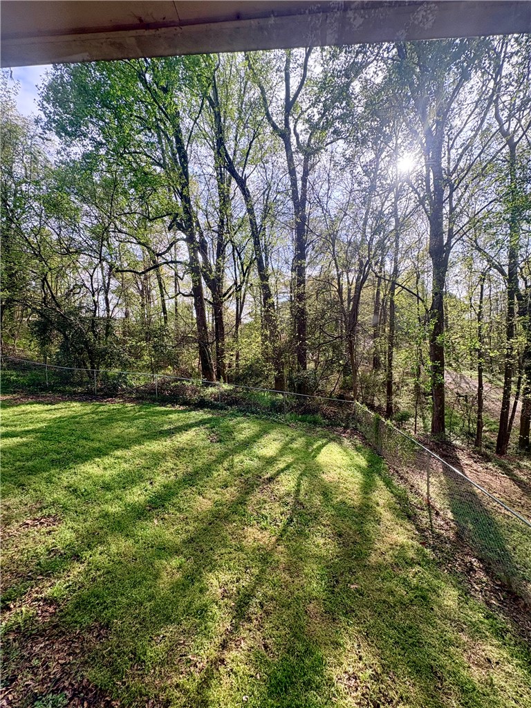 516 Carole Avenue Anderson, SC 29625 - Photo 29 of 34 This tranquil backyard offers a private, fenced green space bordered by mature trees.