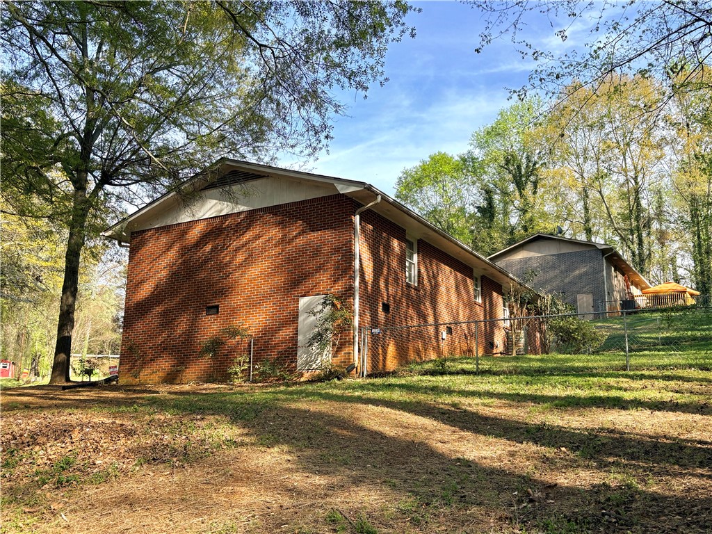 516 Carole Avenue Anderson, SC 29625 - Photo 33 of 34 This property features durable brick construction and a spacious yard with mature trees.