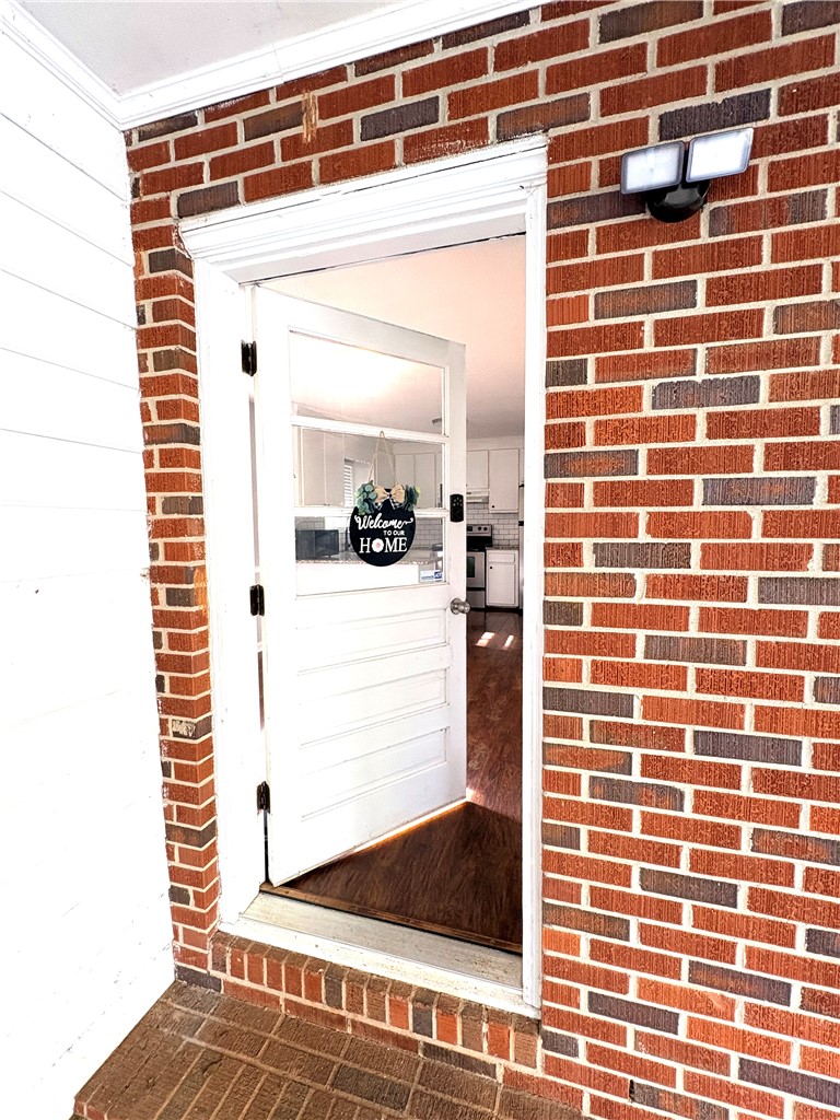 516 Carole Avenue Anderson, SC 29625 - Photo 34 of 34 Enter this charming residence through a welcoming carport entryway revealing warm flooring and a glimpse of the kitchen.