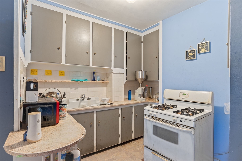 84 Cory Street Fall River, MA 02720 - Photo 12 of 36 a room with a stove and a refrigerator