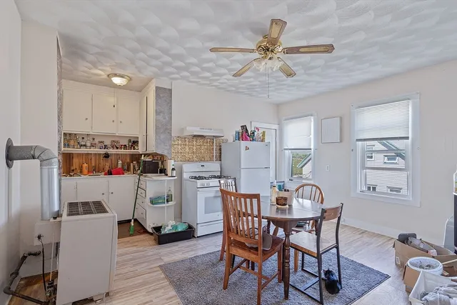 a view of a dining room with furniture and a chandelier