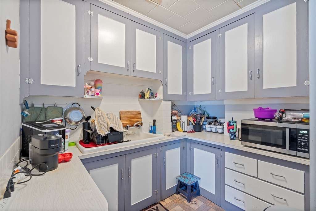 84 Cory Street Fall River, MA 02720 - Photo 28 of 36 a kitchen with a sink cabinets and appliances