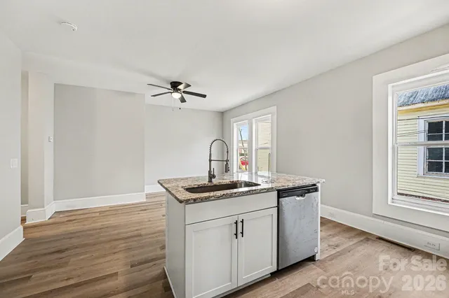 a kitchen with granite countertop stainless steel appliances and wooden cabinets