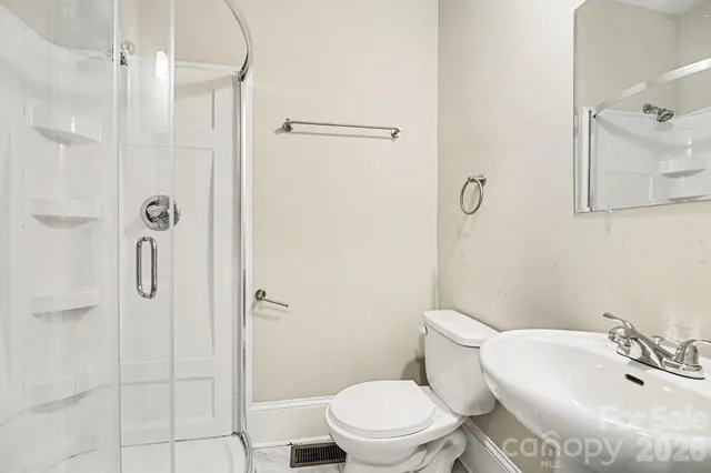 a white toilet sitting next to a bathroom sink