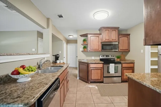 a kitchen with stainless steel appliances granite countertop a sink and stove