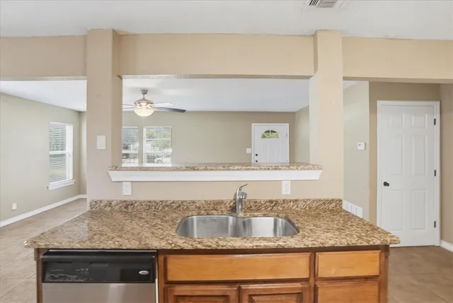 a bathroom with sink granite and a mirror