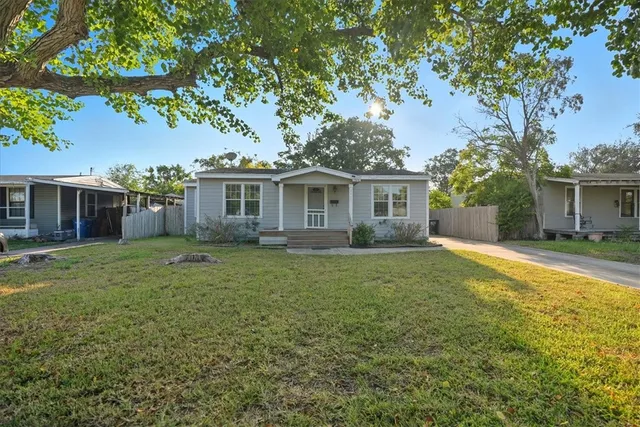 a front view of house with yard and green space