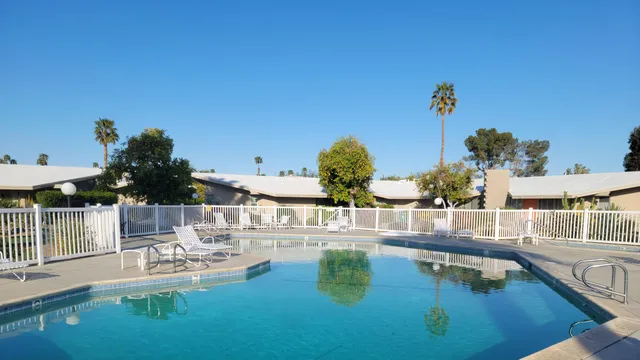 a view of a swimming pool with outdoor seating