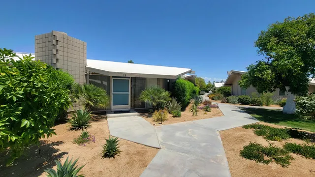 a view of a house with sitting area and garden