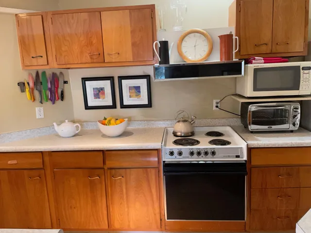 a kitchen with stainless steel appliances granite countertop a stove and a microwave