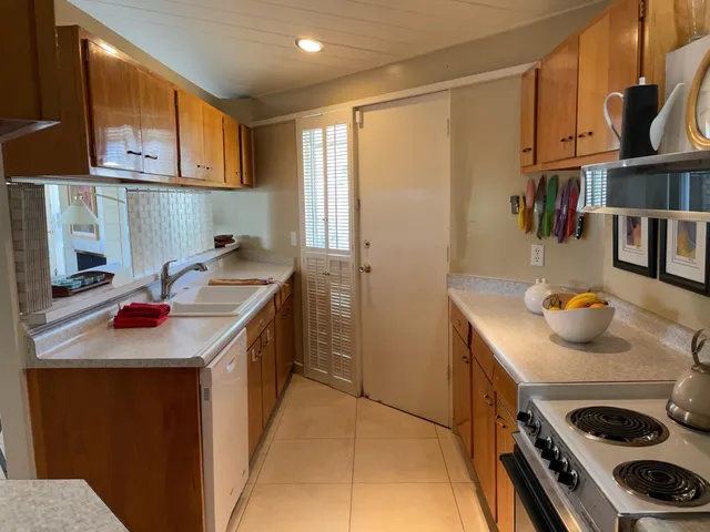 a kitchen with a sink a stove and cabinets