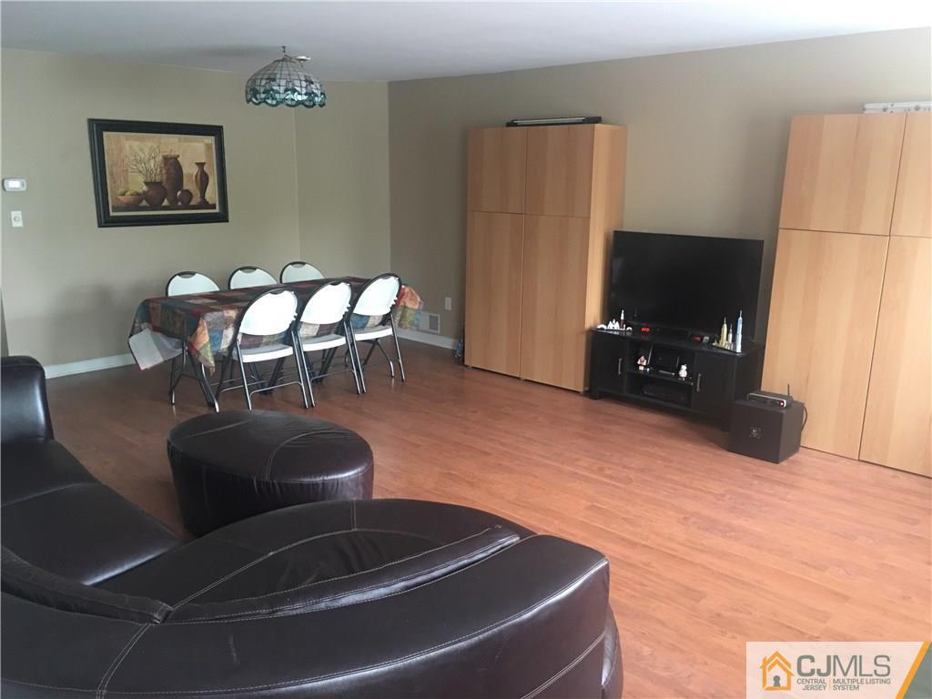 1808 Ridgeview Court Sayreville, NJ 08859 - Photo 2 of 15 a living room with furniture and a flat screen tv