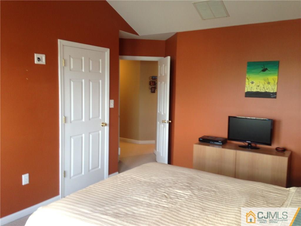1808 Ridgeview Court Sayreville, NJ 08859 - Photo 13 of 15 a bedroom with a bed and a flat screen tv