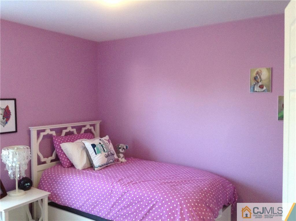 1808 Ridgeview Court Sayreville, NJ 08859 - Photo 4 of 15 a bedroom with pink bed and a couch
