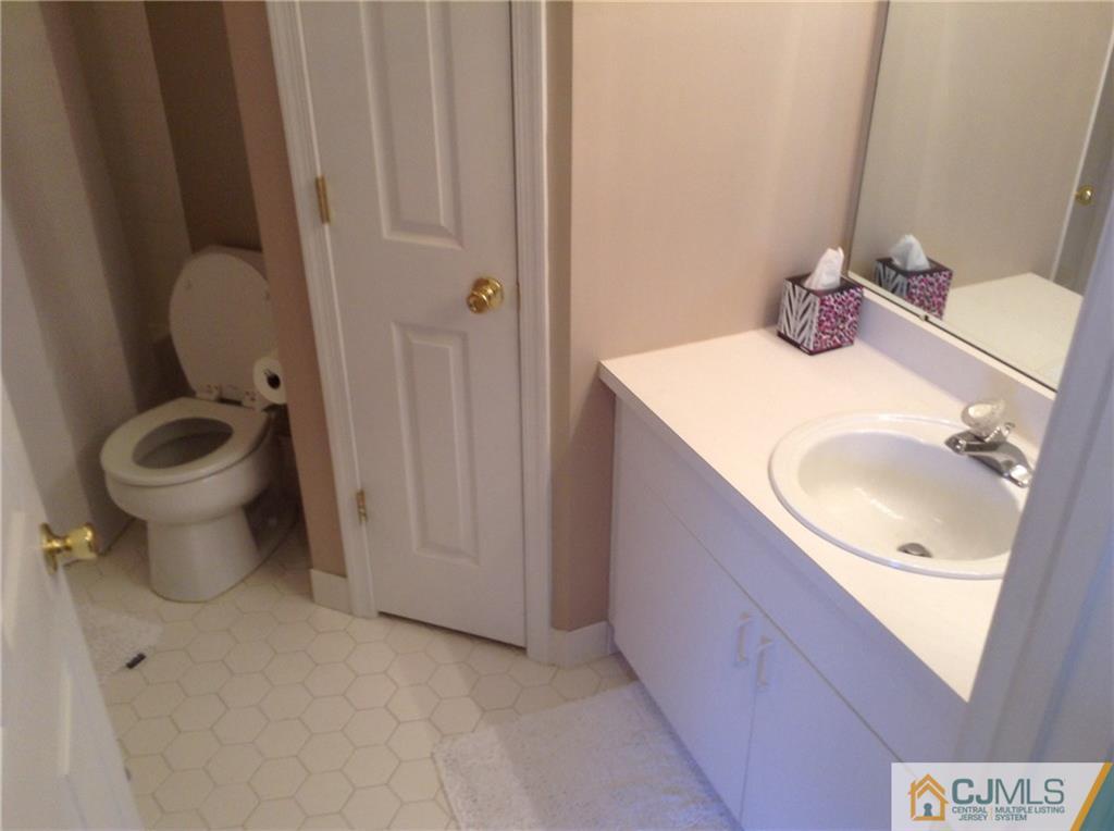 1808 Ridgeview Court Sayreville, NJ 08859 - Photo 7 of 15 a bathroom with a granite countertop sink and a mirror