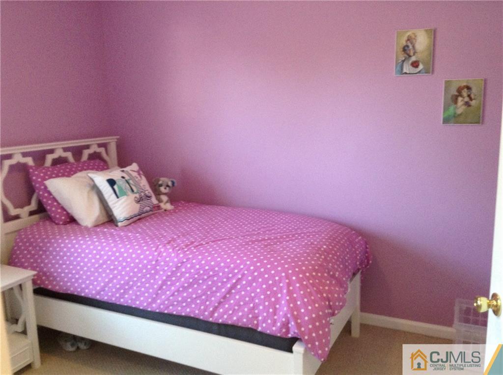 1808 Ridgeview Court Sayreville, NJ 08859 - Photo 8 of 15 a bedroom with pink bed and a pink wall