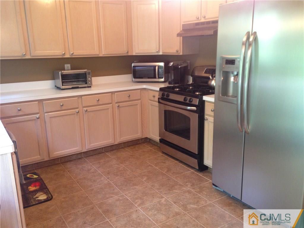 1808 Ridgeview Court Sayreville, NJ 08859 - Photo 10 of 15 a kitchen with stainless steel appliances granite countertop a refrigerator sink and stove