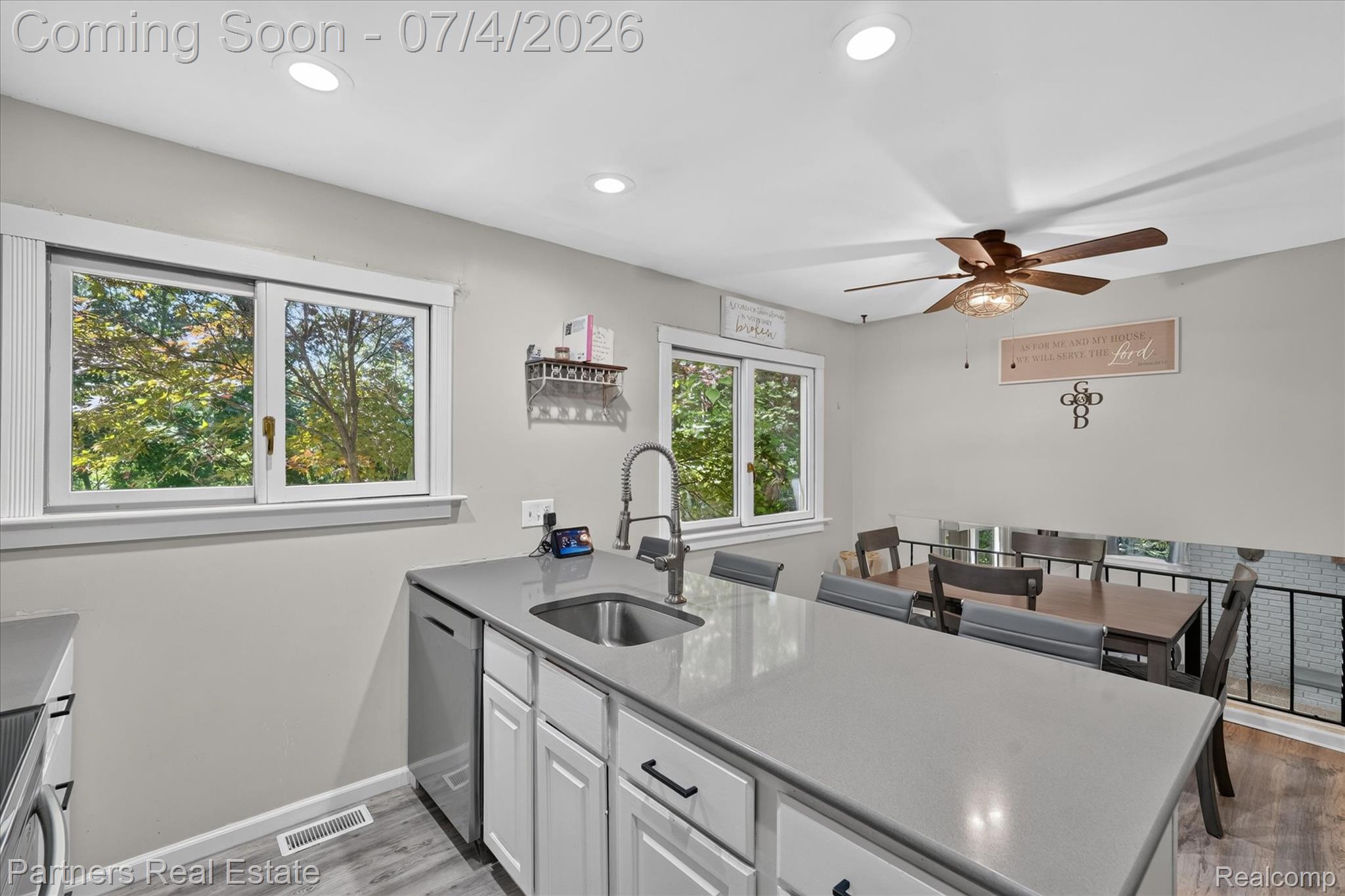 2500 Hubert Road Brighton, MI 48114 - Photo 13 of 53 Modern kitchen featuring an island with a stainless steel sink and a gooseneck faucet