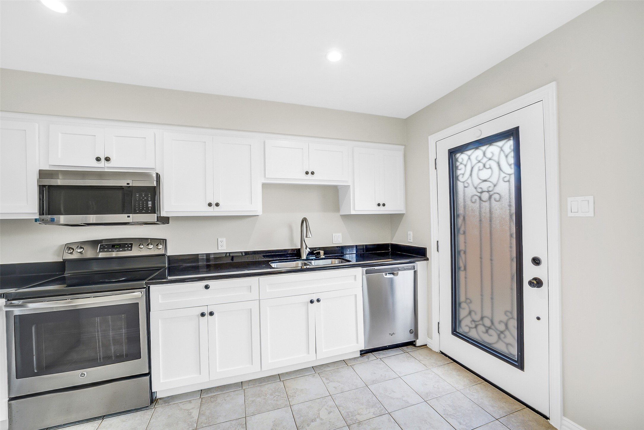 6531 Wanda Lane Houston, TX 77074 - Photo 11 of 29 a kitchen with granite countertop white cabinets and stainless steel appliances